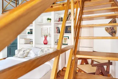 a living room with stairs and a couch at iFlat Shabby Chic Apartament in Rome
