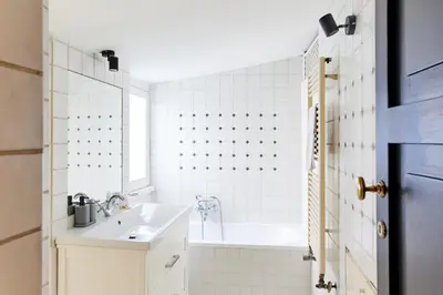 a white bathroom with a tub and a sink at iFlat Shabby Chic Apartament in Rome