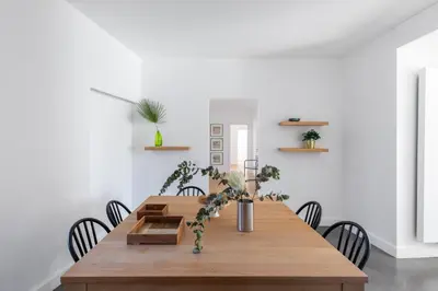a dining room with a wooden table with chairs at iFlat Bright and Modern Flat near the Pantheon in Rome