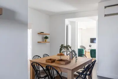 a dining room with a wooden table and chairs at iFlat Bright and Modern Flat near the Pantheon in Rome