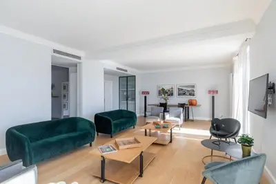 a living room with two green couches and a table at iFlat Bright and Modern Flat near the Pantheon in Rome