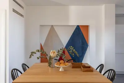 a dining room with a wooden table with chairs at iFlat Bright and Modern Flat near the Pantheon in Rome