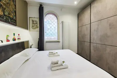 a bedroom with a large bed with towels on it at iFlat One step from Colosseum in Rome