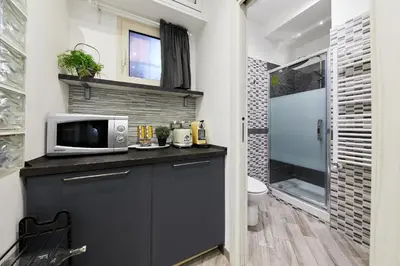 a kitchen with a microwave on top of a counter at iFlat One step from Colosseum in Rome