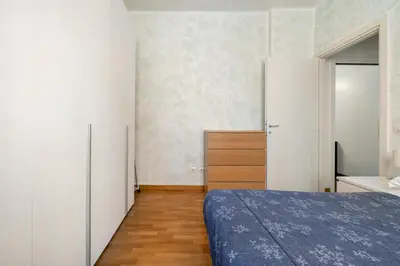 a bedroom with a bed and a dresser at Comfortable apartment Via Appia - B in Rome