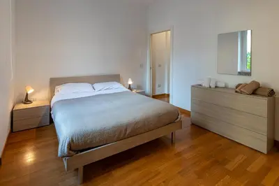 a bedroom with a bed and two dressers and a window at Domus Villa Scipioni in Rome