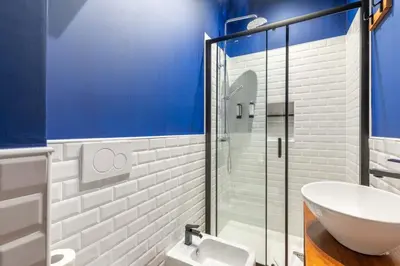 a bathroom with a sink and a glass shower at Koba Rooms Nomentano in Rome