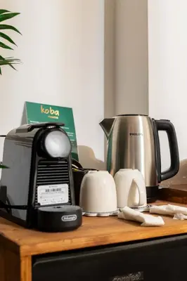 a kitchen counter with a toaster and a coffee maker at Koba Rooms Nomentano in Rome