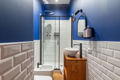 a bathroom with a sink and a glass shower at Koba Rooms Nomentano in Rome