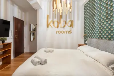 a bedroom with a large bed with towels on it at Koba Rooms Nomentano in Rome