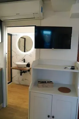 a bathroom with a sink and a tv on the wall at San Peter View in Rome