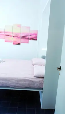 a bed in a room with a painting on the wall at Appartamento 