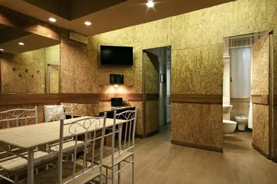 a dining room with a table and a tv on the wall at Back to 70's-Modern and Terrace in Rome