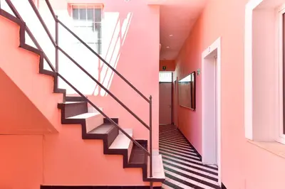 a staircase in a building with a pink wall at FanfullArt in Rome