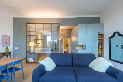 a living room with a blue couch and a table at Luna's Apartment BuddyRent in Rome
