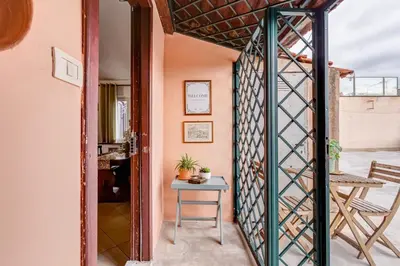 an open door to a room with a table and a chair at BDC - Penthouse Brancaccio in Rome