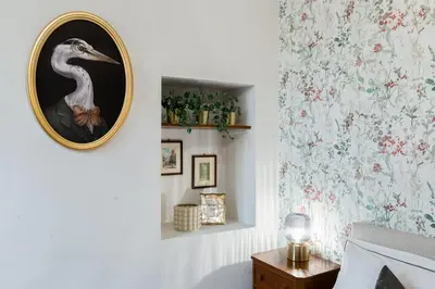 a room with a picture of a bird on the wall at BDC - Penthouse Brancaccio in Rome