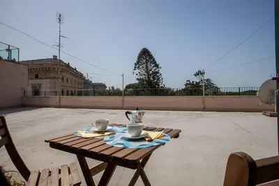 a table with two cups and a tea pot on a patio at BDC - Penthouse Brancaccio in Rome