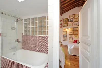 a bathroom with a tub and a glass shower at Spagna in Rome