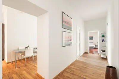 a dining room with a table and a white wall at Vatican Lovely 2BR Apartment with Terrace in Rome