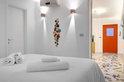 a bedroom with a white bed with towels on it at Flaminio Charme Apartment in Rome