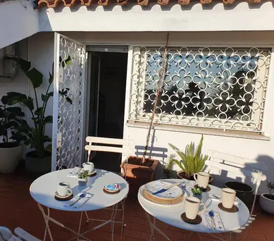 two tables sitting on a patio with a window at Appartamento 