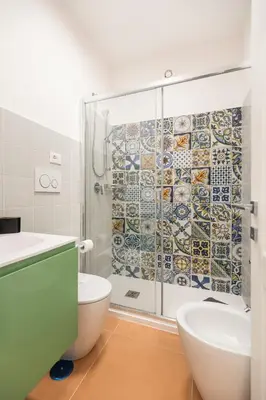 a bathroom with a shower with a toilet and a sink at Supreme Apartments Vaticano in Rome