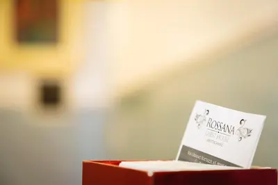 a book sitting on top of a red box at Rossana House in Rome