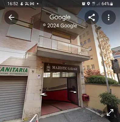 a building with a red door and a garage at DOMUS GELSOMINO in Rome