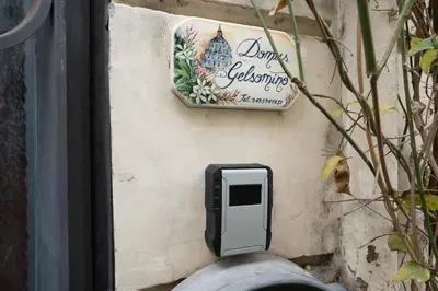 a mailbox on the side of a wall with a sign at DOMUS GELSOMINO in Rome
