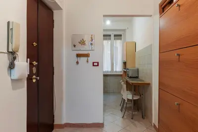a hallway with a room with a desk and a door at GuestHost - Piazzale delle Provincie Apartment in Rome