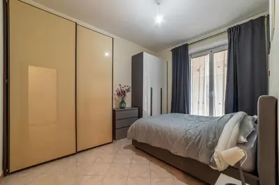a bedroom with a bed and a large closet at GuestHost - Piazzale delle Provincie Apartment in Rome