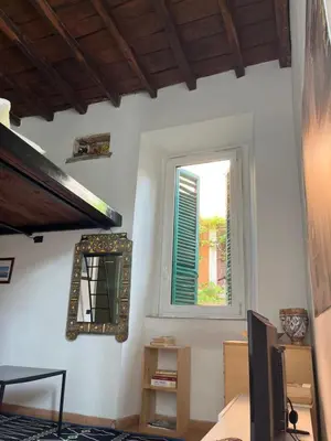 a room with a window and a mirror on the wall at Anna’s home in Rome