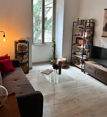a living room with a couch and a glass coffee table at La Casa di Testaccio Apartment in Rome