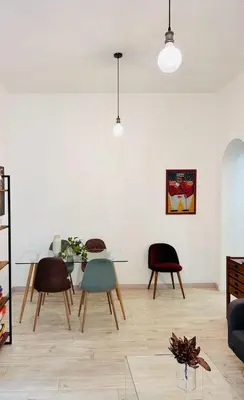 a living room with a glass table and chairs at La Casa di Testaccio Apartment in Rome