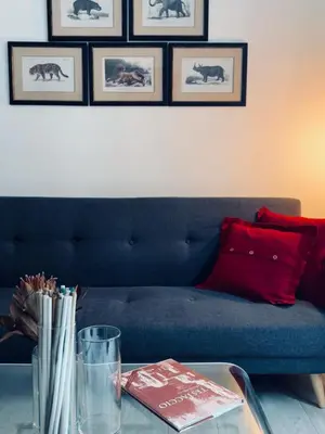a living room with a blue couch and a table at La Casa di Testaccio Apartment in Rome