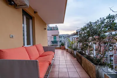 an apartment balcony with a couch on a balcony at ArtStay - Luxury Penthouse Metro B, Tiburtina in Rome