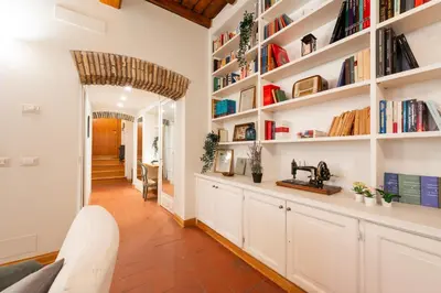 a library with white shelves and a sink in a room at Orso 70 apartment in Rome