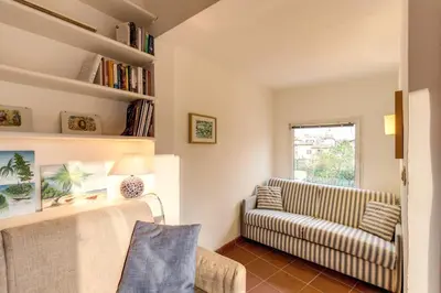 a living room with a couch and a chair at Amazing penthouse with terrace near Navona Square in Rome