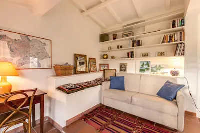 a living room with a couch and bookshelves at Amazing penthouse with terrace near Navona Square in Rome