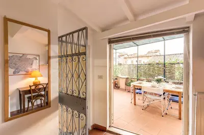 a door leading to a dining room with a table at Amazing penthouse with terrace near Navona Square in Rome