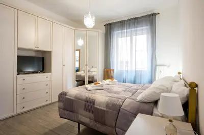 a bedroom with a large bed and a television at La Maison de la Couturière in Rome