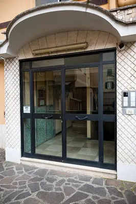 an entrance to a building with a large glass door at La Maison de la Couturière in Rome