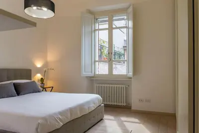 a bedroom with a large bed and a window at Borgo Charme Elegante e Unico. Dimora da Sogno in Rome