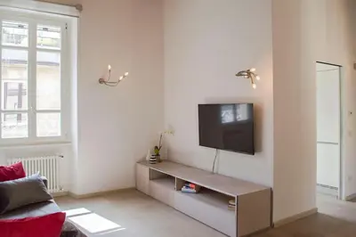 a living room with a flat screen tv on a wall at Borgo Charme Elegante e Unico. Dimora da Sogno in Rome