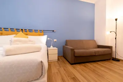 a bedroom with a bed and a chair at BDC - Euphoria 2BDR at Vatican in Rome
