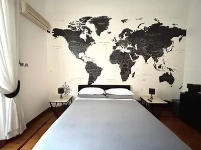 a bedroom with a map of the world on the wall at B&B Gelsomina Apartment in Rome