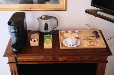 a table with a coffee maker and food on it at B&B Gelsomina Apartment in Rome