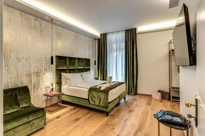 a bedroom with a bed and a chair and a couch at Goldoni 47 in Rome