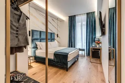 a bedroom with a bed and a mirror at Goldoni 47 in Rome
